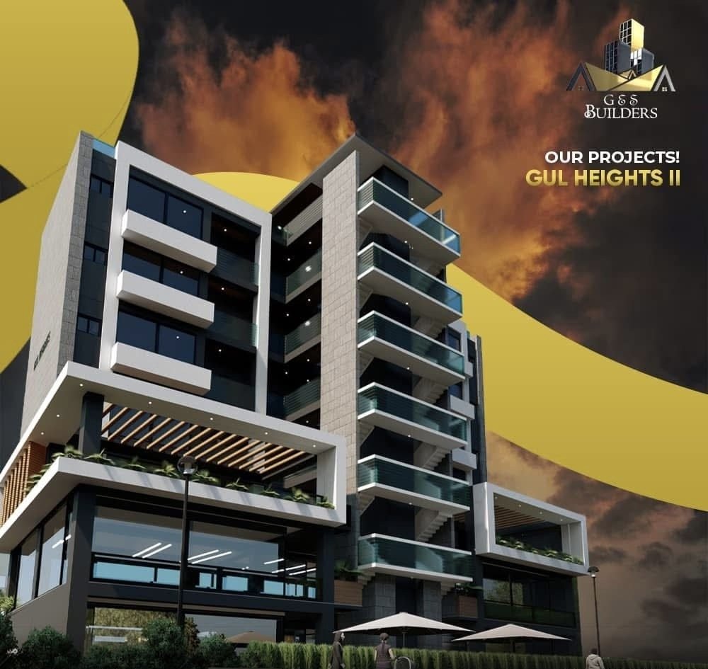 Gul Heights 2 by G & S Builders — the street elevation, balconies stepping above the timber-slatted canopy and the glazed commercial frontage